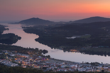 Colorful sunset over Vila Nova de Cerveira and Minho river in the summer. Long exposure shot.