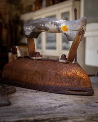 An old iron on a table. 