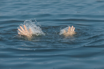 Drowning woman reaching for help in sea, closeup