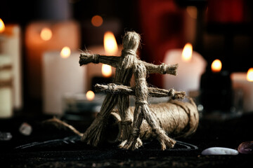 Voodoo dolls on table in dark room. Curse ceremony