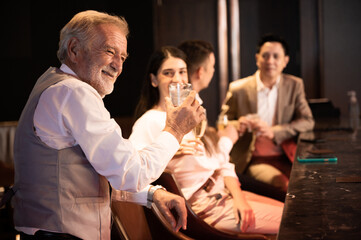 a group of happy office worker drinking alcohol at club with colleagues, celebration after party, relaxing time, nightlife concept with friends, happy smiling.