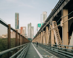 Pedestrian walkway on the Queensboro Bridge and view of buildings in Long Island City, Queens, New York City