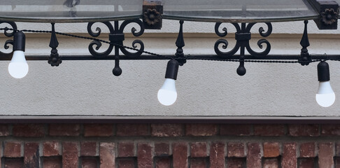 Detail of the lamp. Hanging light bulbs that glow white.