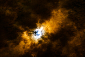 the sun among the dark clouds