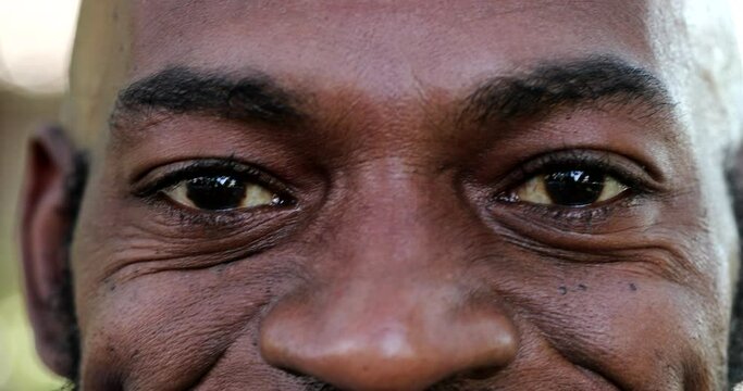 African man close-up eyes looking at camera, macro closeup black person