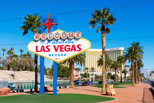 Welcome to Fabulous Las Vegas sign on a bright sunny day. Background Mandalay Bay Resort and Casino tower on Las Vegas Boulevard - Las Vegas, Nevada, USA - 2020