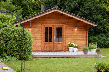  flowers in front of a wooden hut. Garden joy in summer. Relax in the garden and enjoy the...