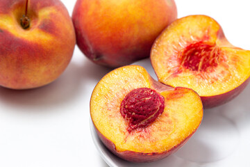 Fototapeta na wymiar Peaches on a white background. Peach cut in half. Healthy diet.