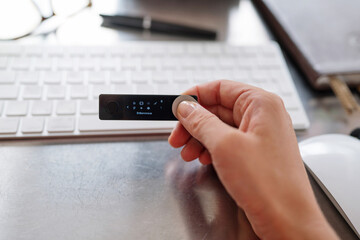 Hand holding crypto hard wallet