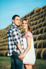 a guy with a girl on a summer walk in the field