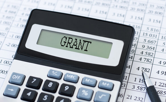 A calculator with the word GRANT on the display