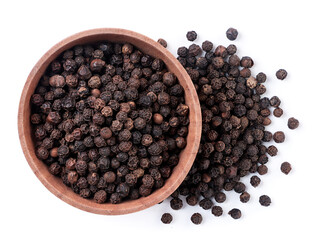 Black peppercorns in a wooden plate on a white background, isolated. Top view