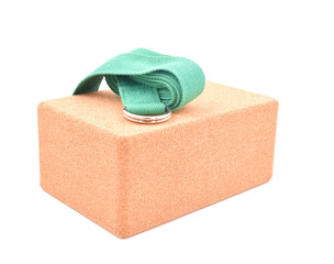 Cork yoga block and green strap isolated on a white background