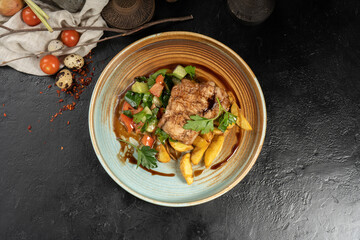 Chop with potato slices and salad