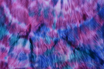 Abstract painted background. Multi-colored pattern in the shibori technique on a thin knitted...