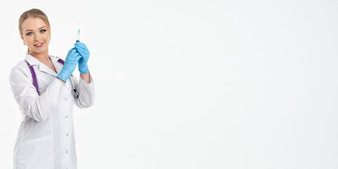 A young nurse in a mask and white coat holds a syringe with a needle for injections, flu shots, covid. The concept of vaccination and protection against influenza, from a pandemic. copy space. banner