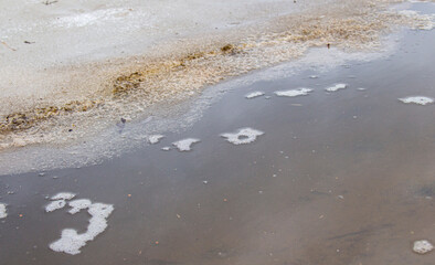 Slush and mud in the water from melting snow during the spring thaw. Spring landscape