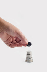 Asian man hand holding Sri Lankan coin, isolated on white Conceptual idea for Marketing growth, banking and finance.