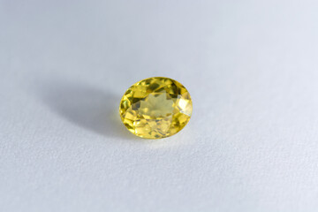 Natural mined lemon greenish-yellow color, transparent, loose, faceted, oval shaped Mali garnet gemstone setting for jewelry making. Rare stone specimen, desired gem. Gemology and mineralogy theme.