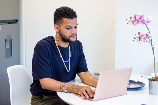 Young black man working with a computer at home