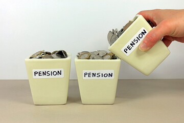 A Hand Tipping A Pension Pot In To Another. Consolidating Multiple Pensions Concept