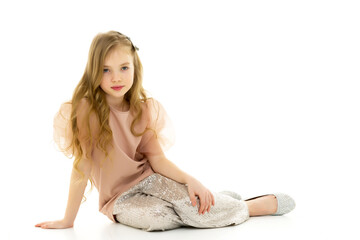 Fototapeta premium Little girl is sitting on the floor.The concept of a happy child