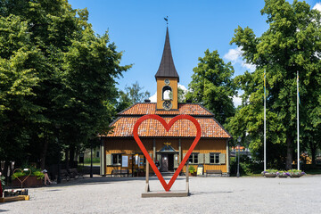 The central square of the city of Sigtuna. Old wooden church built at the past centuries. Landmarks of the ancient capital of Sweden. Installation in the form of heart shape for photographing lovers.
