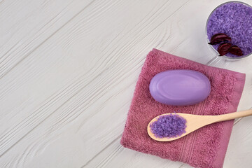 Top view towel with soap and spoon with salt.