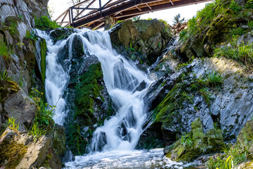 Waterfall flowing down from under the bridge
