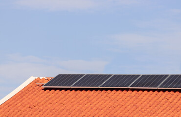 Solar photovoltaic panels on a roof at sunset. Clean energy modern house or company concept image....