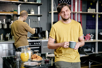 Guy Having Drink in Kitchen