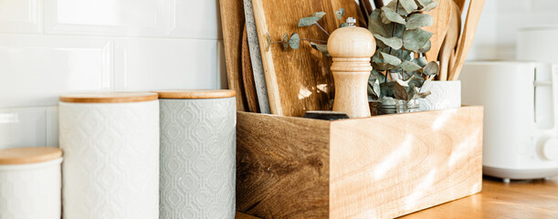 kitchen details, accessories, ceramic jars, wooden table, white ceramic brick wall background....