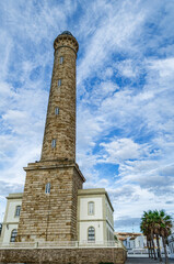 Fototapeta premium The Chipiona lighthouse surrounded by clouds.