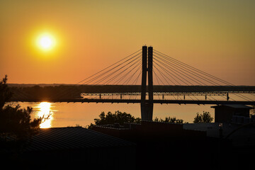 Fototapeta na wymiar Bridge across the river at sunset