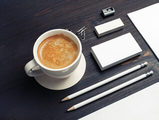 Blank corporate identity. Stationery set and coffee cup on wood table background. Branding mockup.