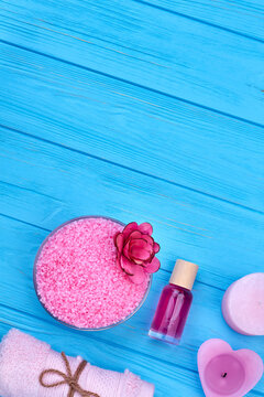 Flat Lay Pile Of Pink Salt With Bottle Of Perfume And Candle.