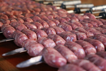 Linguiça. Various raw pork sausages on various skewers