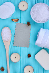 Top view flat lay items for spa treatment on blue wood.
