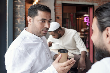 Arabian Man Drinking Coffee With Friend