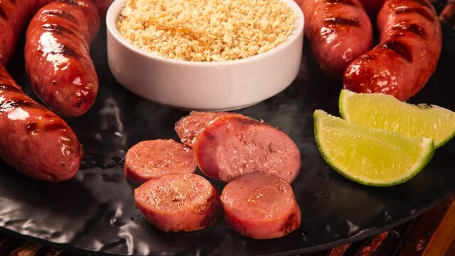 Grilled sausage with smoke. Grilled Sausage on wooden board. Brazilian barbecue.