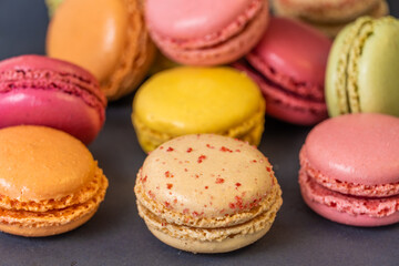Fototapeta na wymiar Macarons on dark background, colourful french cookies macarons. 