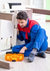 Repair contractor repairing broken furniture at home