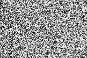 Grunge texture of a wall made of small stones. Monochrome background of fine gravel with spots, noise and grain. Overlay template. Vector illustration