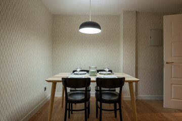 dining table with four services placed in the office of a contemporary design house