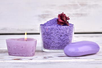 Obraz na płótnie Canvas Purple salt with soap and candle on white background.