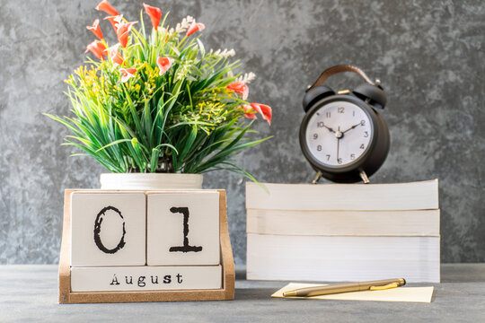 August 1st. August 1 wooden cube calendar with blur objects on background.