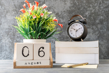 August 6th. August 6 wooden cube calendar with blur objects on background.