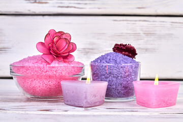 Still life colored himalayan salt and burning candles.