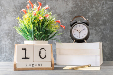 August 10th. August 10 wooden cube calendar with blur objects on background.