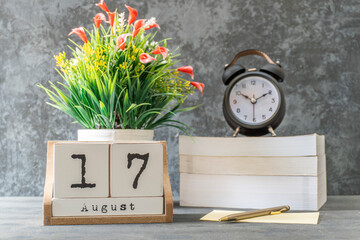 August 17th. August 17 wooden cube calendar with blur objects on background.